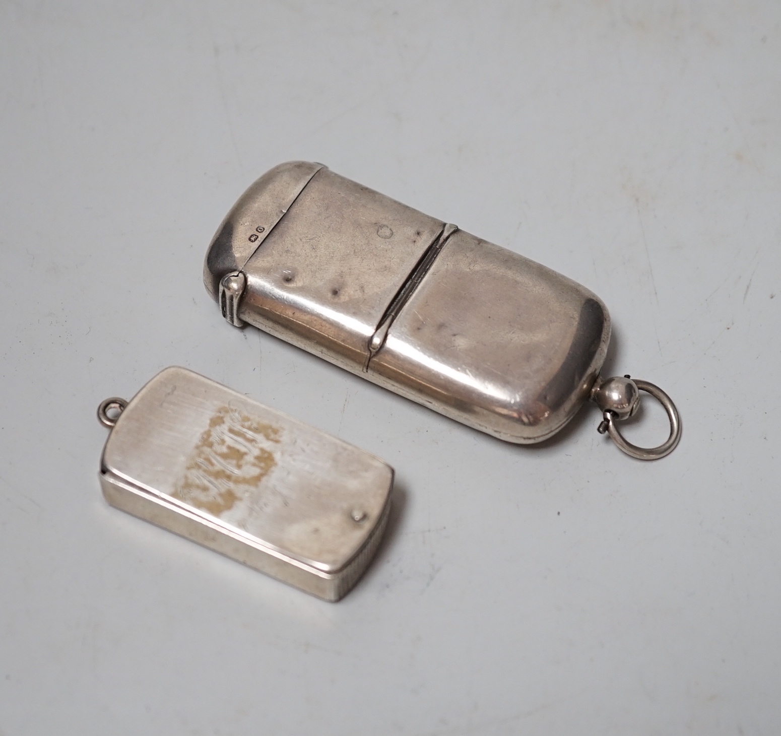 A late Victorian silver combination vesta and sovereign case, William Neal & Son, Chester, 1897, 70mm and a silver silver slide-action vesta case by Sampson Mordan & Co.